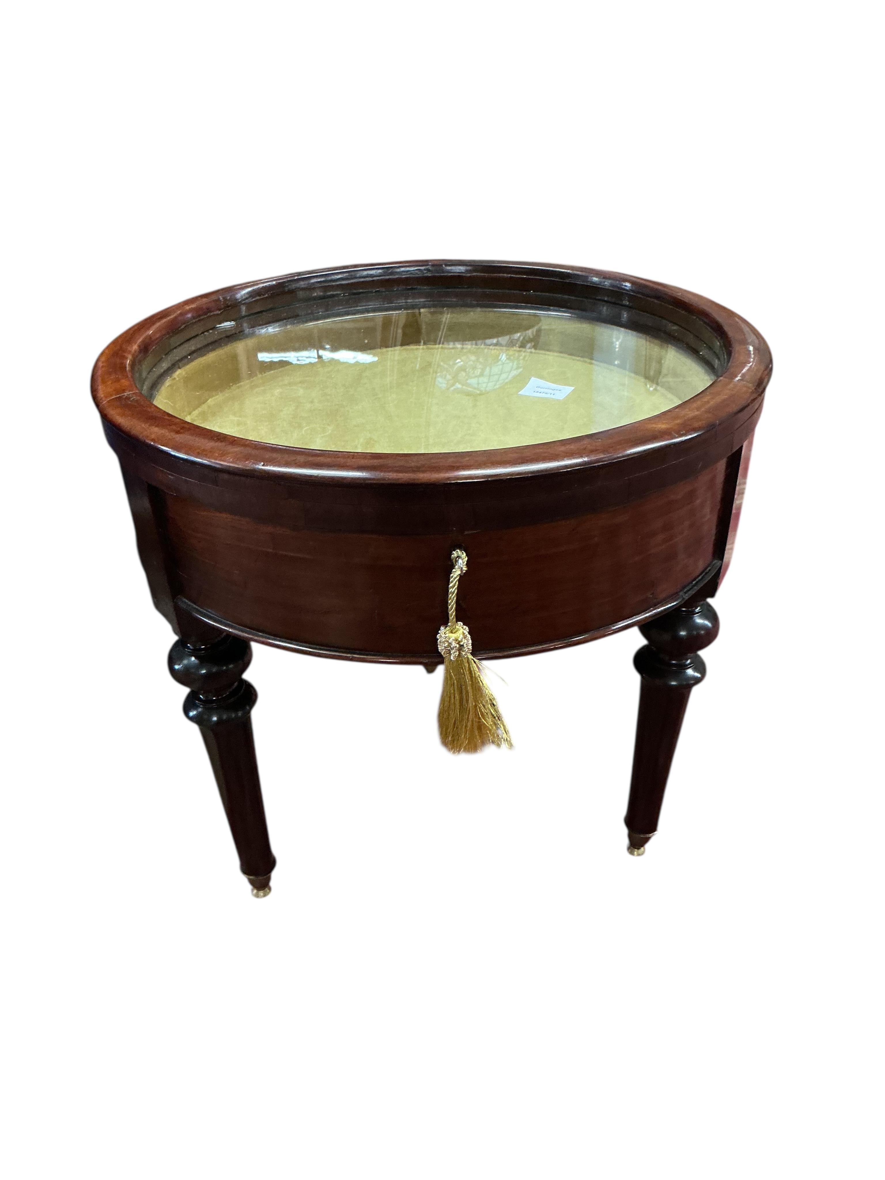 A Victorian style circular mahogany low bijouterie table, diameter 60cm, height 58cm